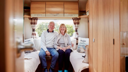 A couple inside their campervan 